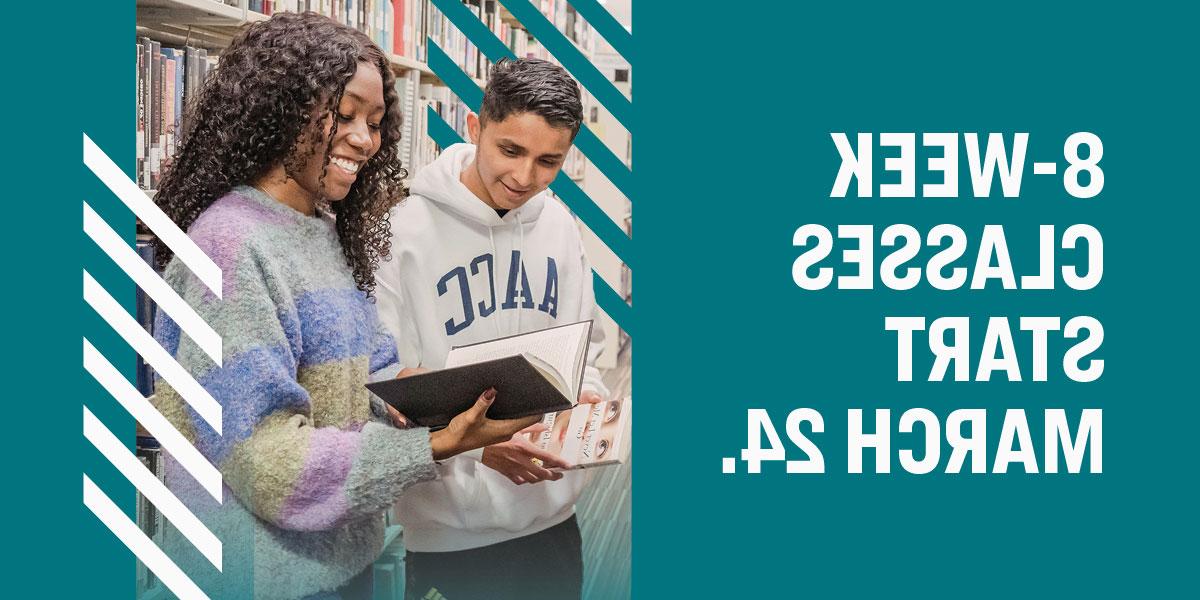 Two students holding books in library. Text that says, 